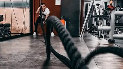 Athletes training with barbells inside a modern CrossFit gym in Madurai.