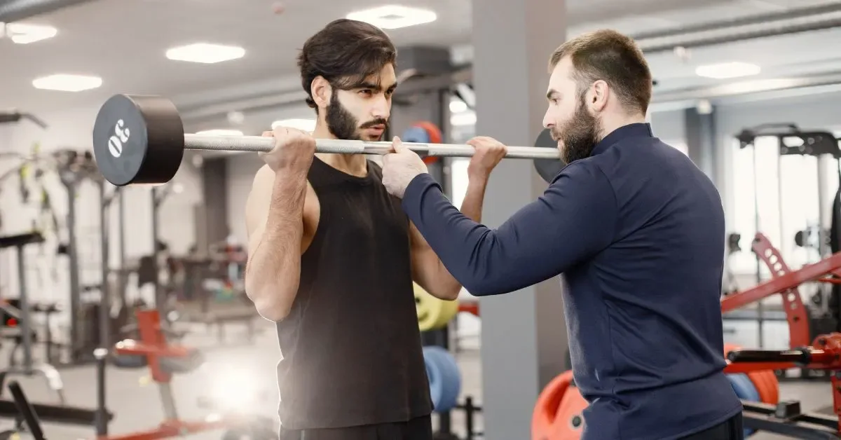 Personal trainer working with a client in a Madurai gym.