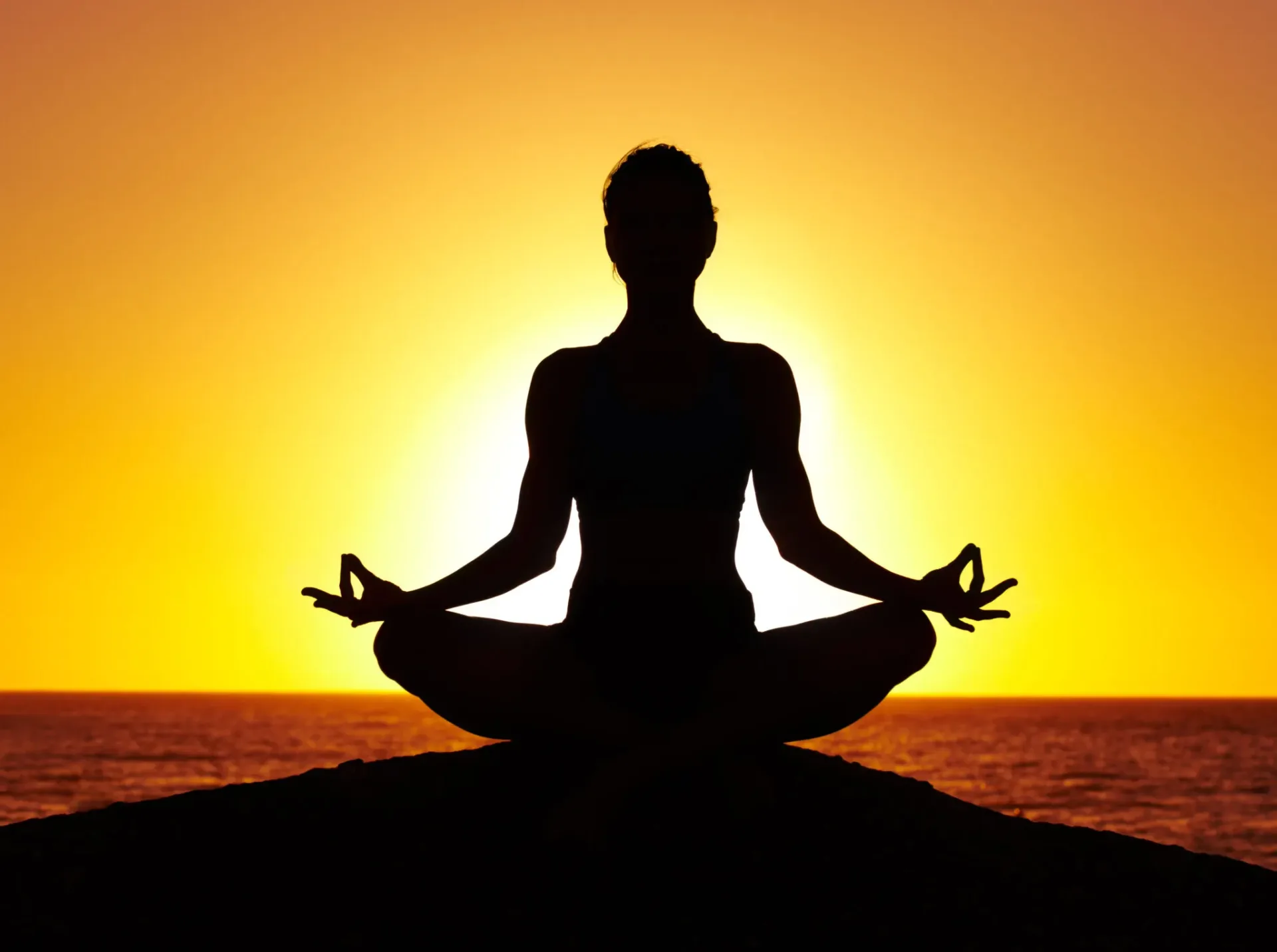 Person practicing yoga in a serene studio setting.